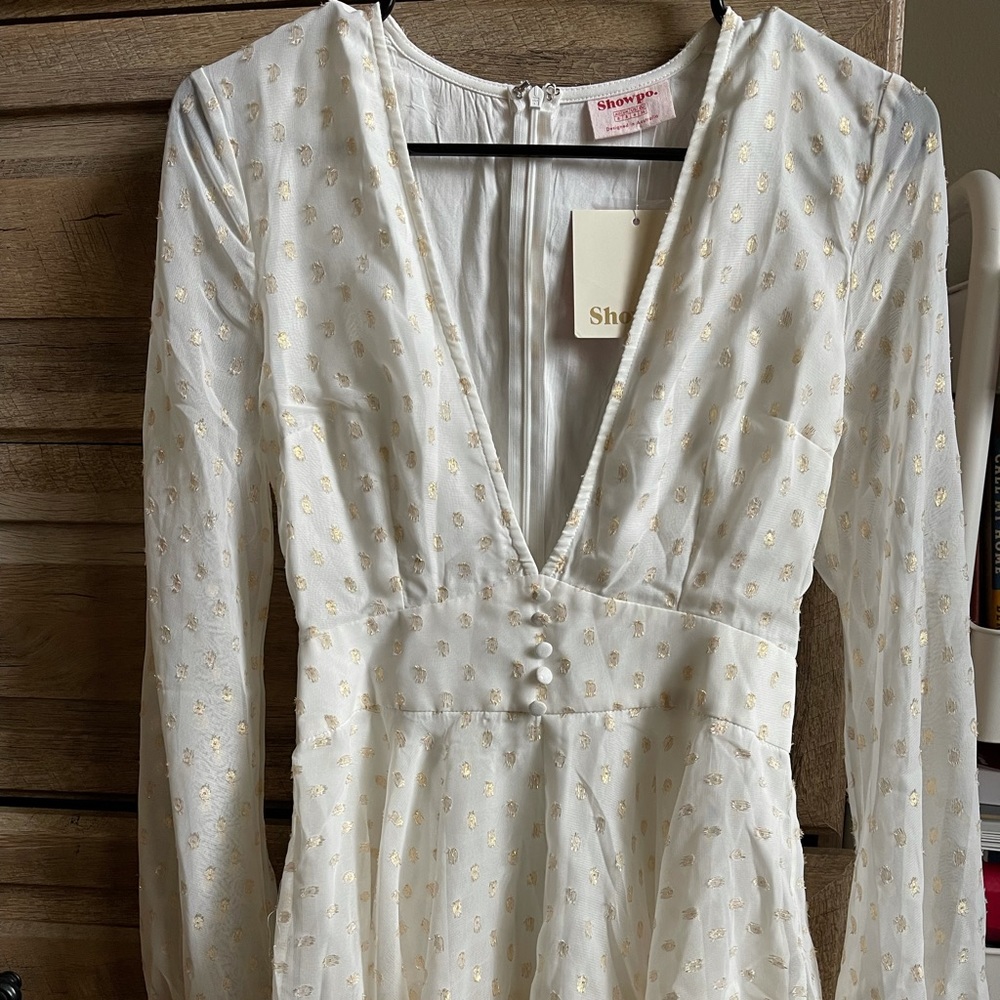 White romper with gold accents
